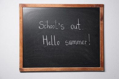 Photo of Phrases School's Out and Hello Summer with exclamation mark on blackboard