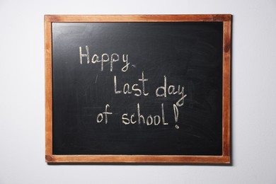 Photo of Phrase Happy Last Day of School with exclamation mark on blackboard