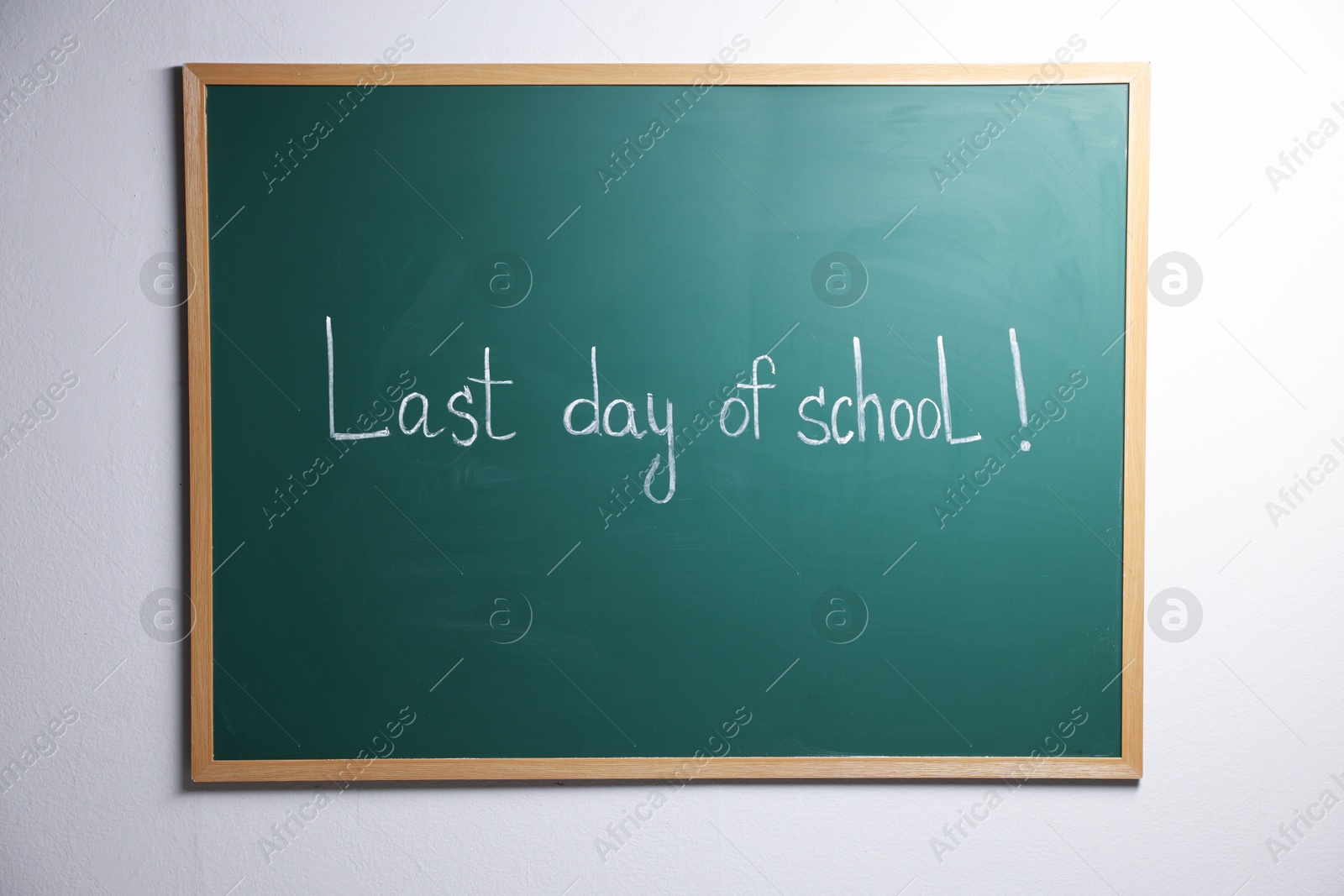 Phrase Last Day of School with exclamation mark on blackboard Photo of Phrase Last Day of School with exclamation mark on blackboard