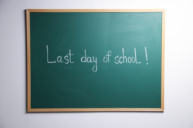 Photo of Phrase Last Day of School with exclamation mark on blackboard