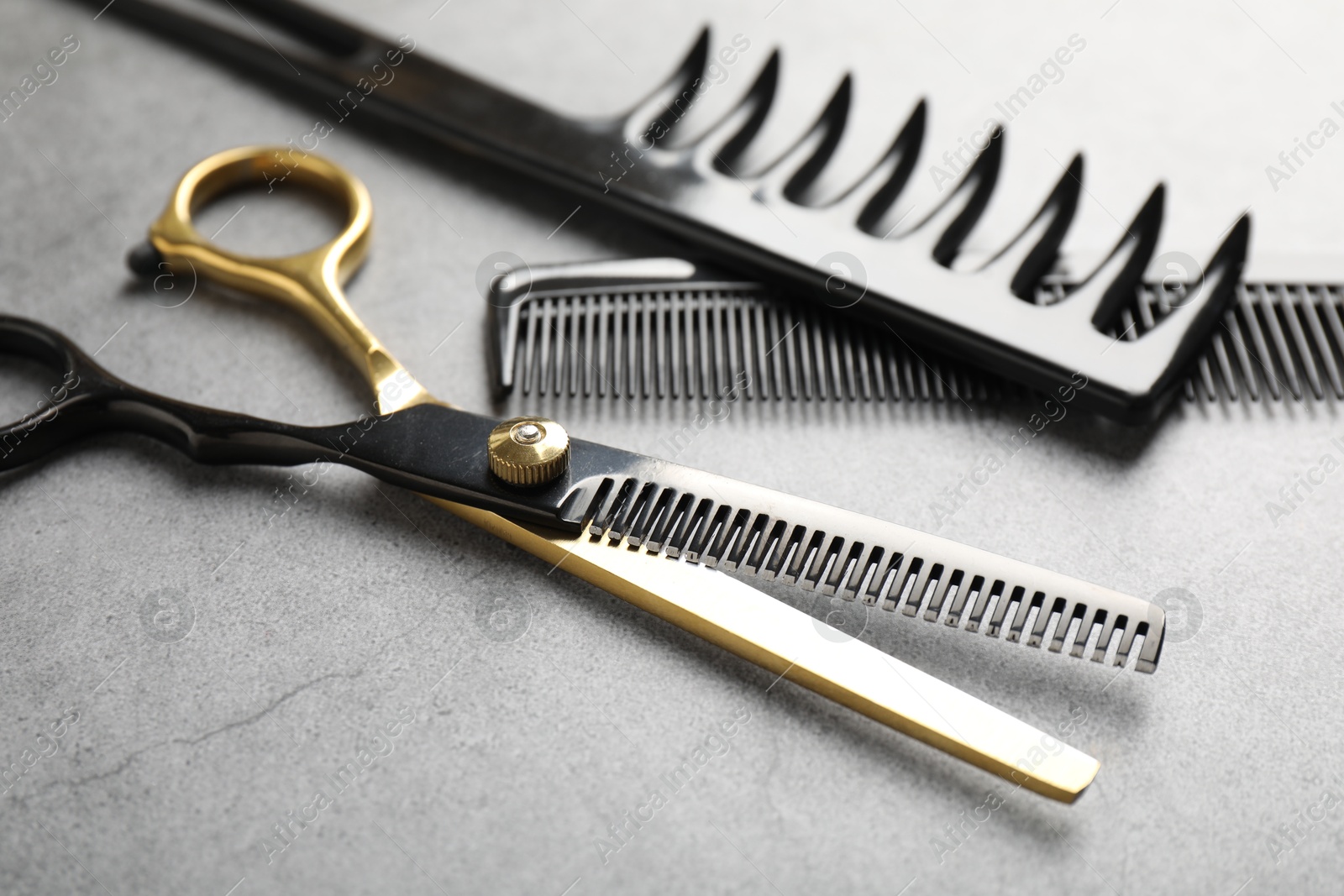 Different hairdresser's tools on grey table, closeup Photo of Different hairdresser's tools on grey table, closeup