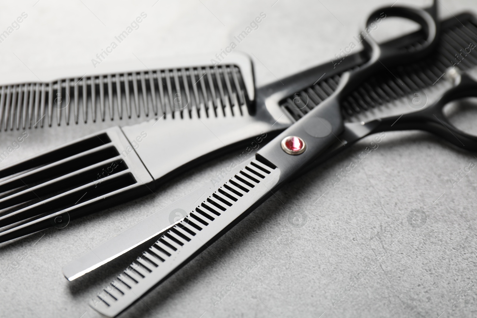 Different hairdresser's tools on grey table, closeup Photo of Different hairdresser's tools on grey table, closeup