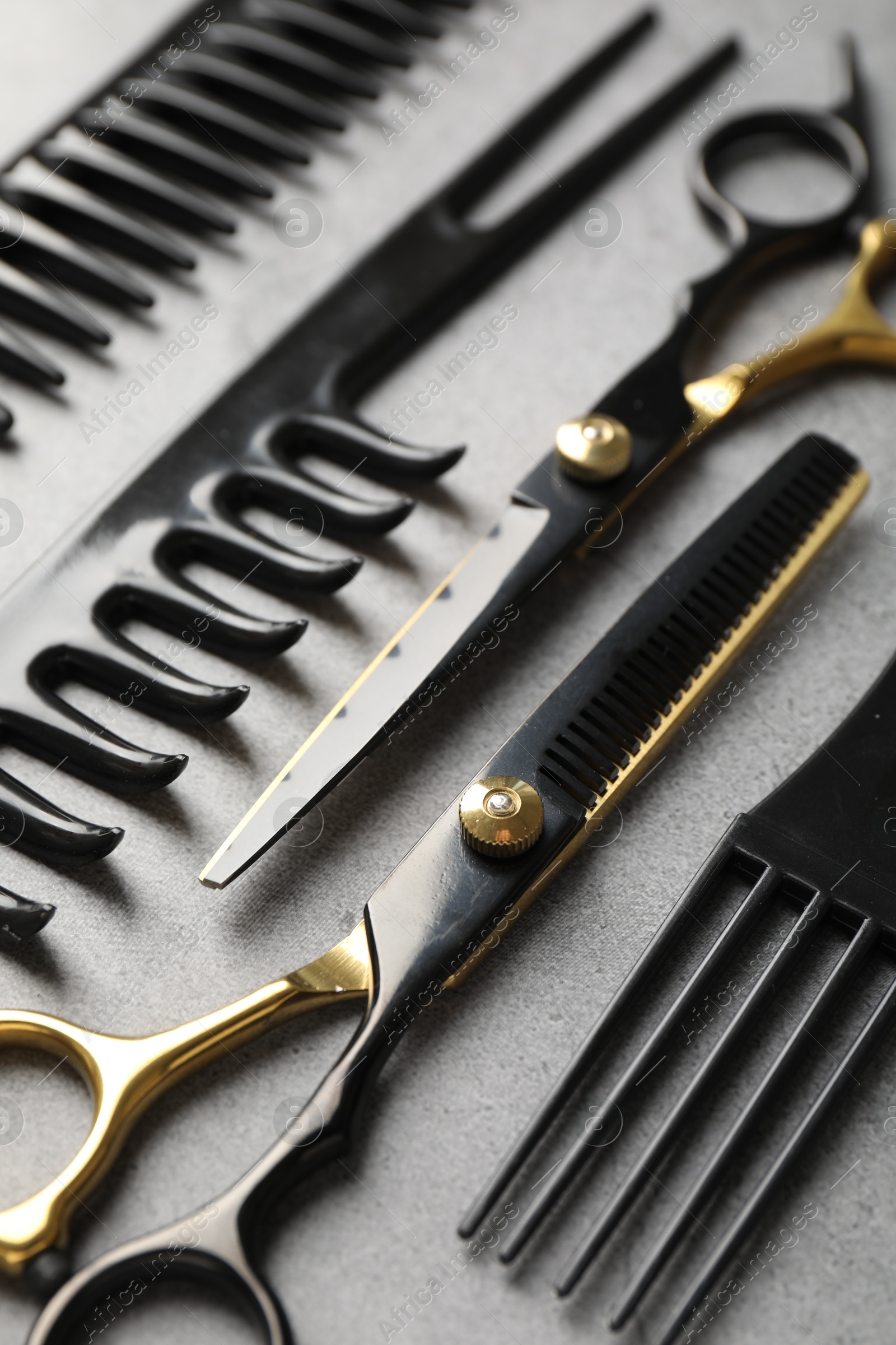 Different hairdresser's tools on grey table, closeup Photo of Different hairdresser's tools on grey table, closeup