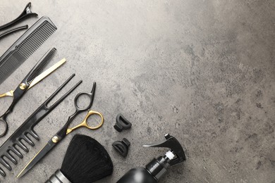 Photo of Different hairdresser's tools on grey table, flat lay. Space for text