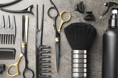 Photo of Different hairdresser's tools on grey table, flat lay