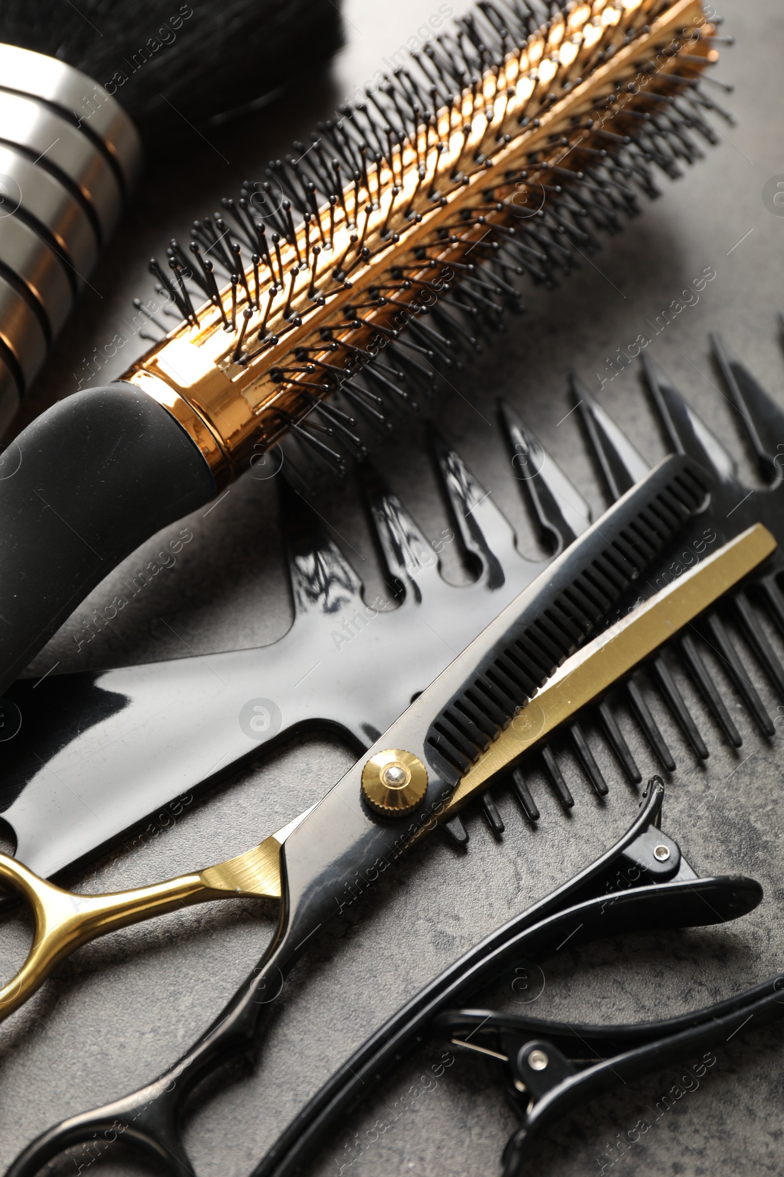 Different hairdresser's tools on grey table, closeup Photo of Different hairdresser's tools on grey table, closeup