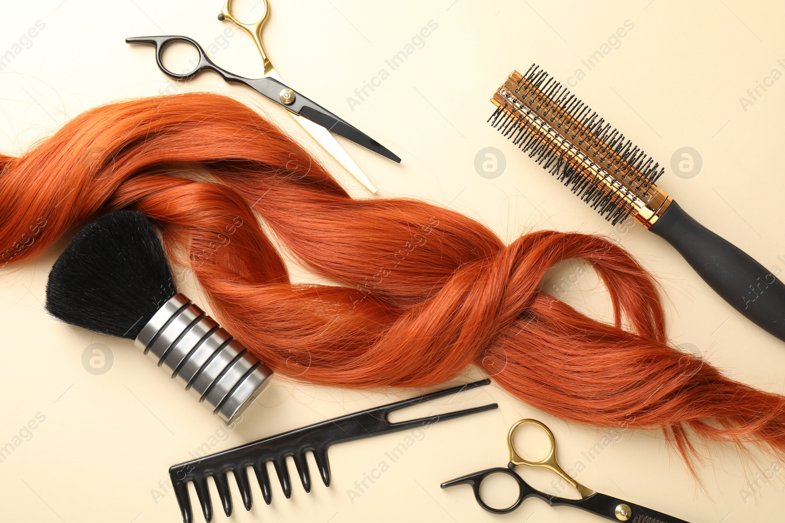 Hair locks and different hairdresser's tools on beige background, flat lay Photo of Hair locks and different hairdresser's tools on beige background, flat lay