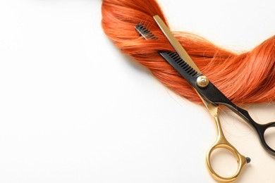 Photo of Hair lock and scissors on white background, above view. Space for text