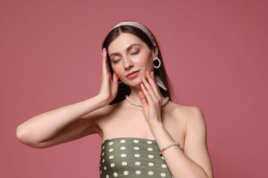 Photo of Fashionable portrait of beautiful woman in stylish outfit on pink background