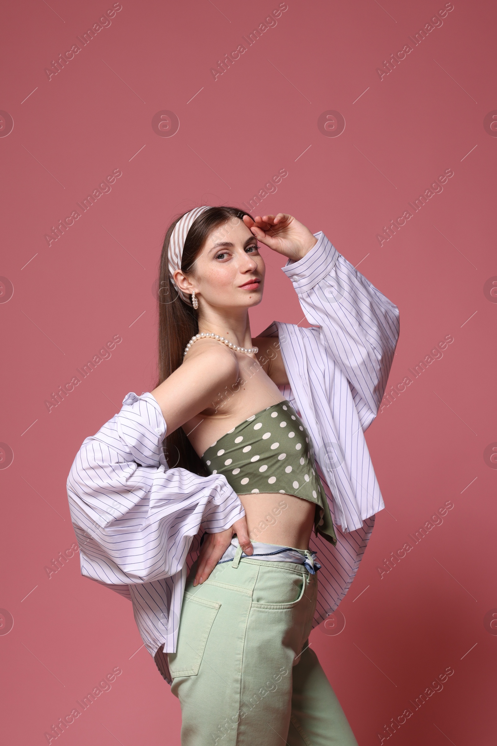 Fashionable portrait of beautiful woman in stylish outfit on pink background Photo of Fashionable portrait of beautiful woman in stylish outfit on pink background
