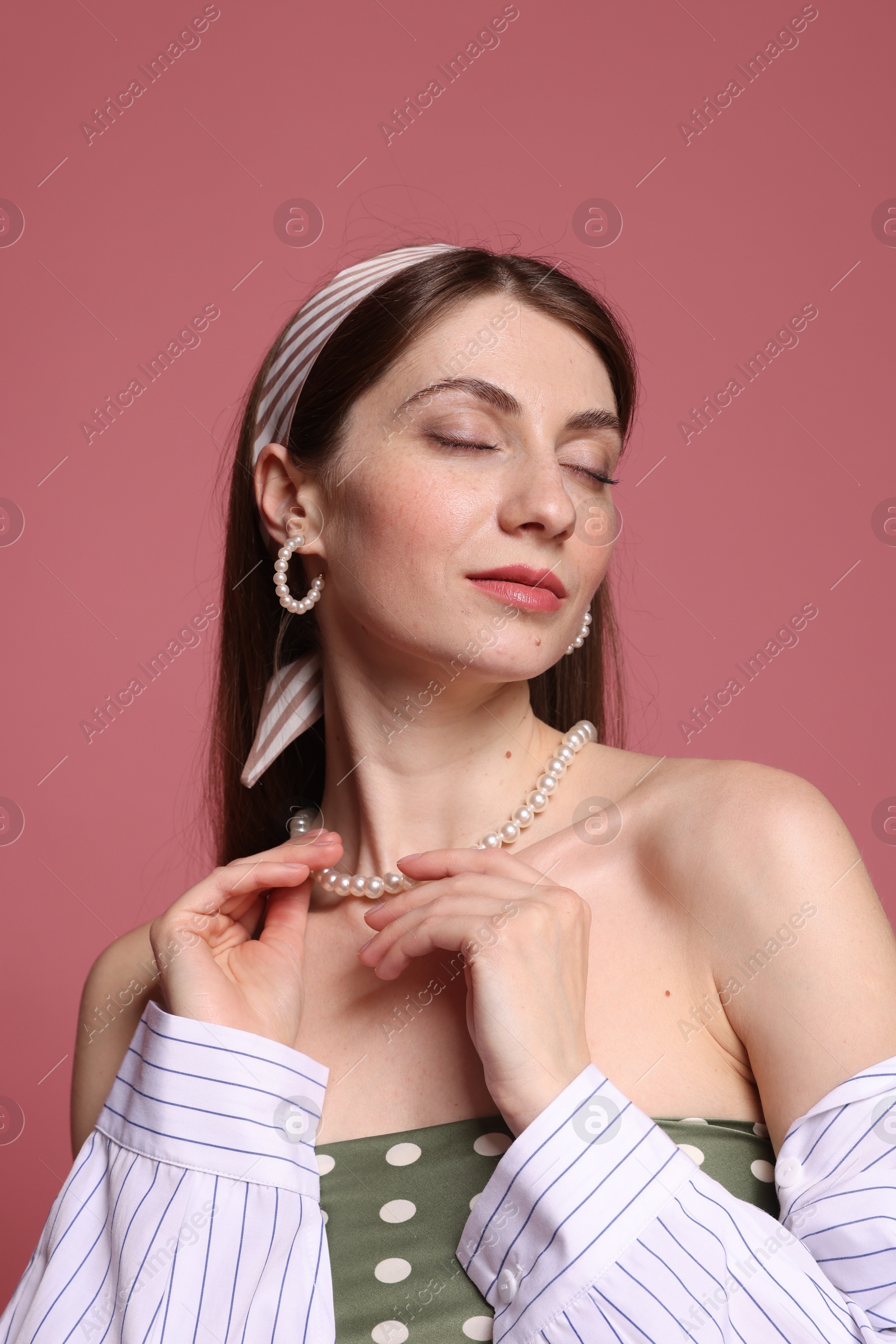 Fashionable portrait of beautiful woman in stylish outfit on pink background Photo of Fashionable portrait of beautiful woman in stylish outfit on pink background
