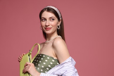 Photo of Fashionable portrait of beautiful woman in stylish outfit on pink background