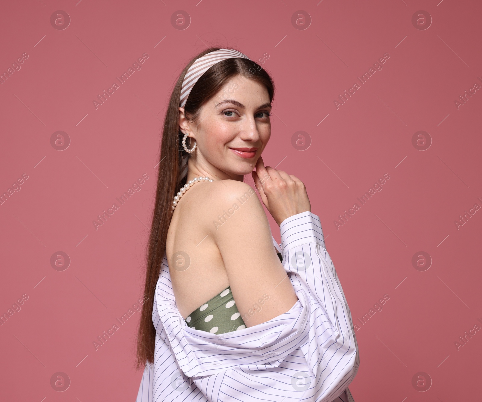 Fashionable portrait of beautiful woman in stylish outfit on pink background Photo of Fashionable portrait of beautiful woman in stylish outfit on pink background