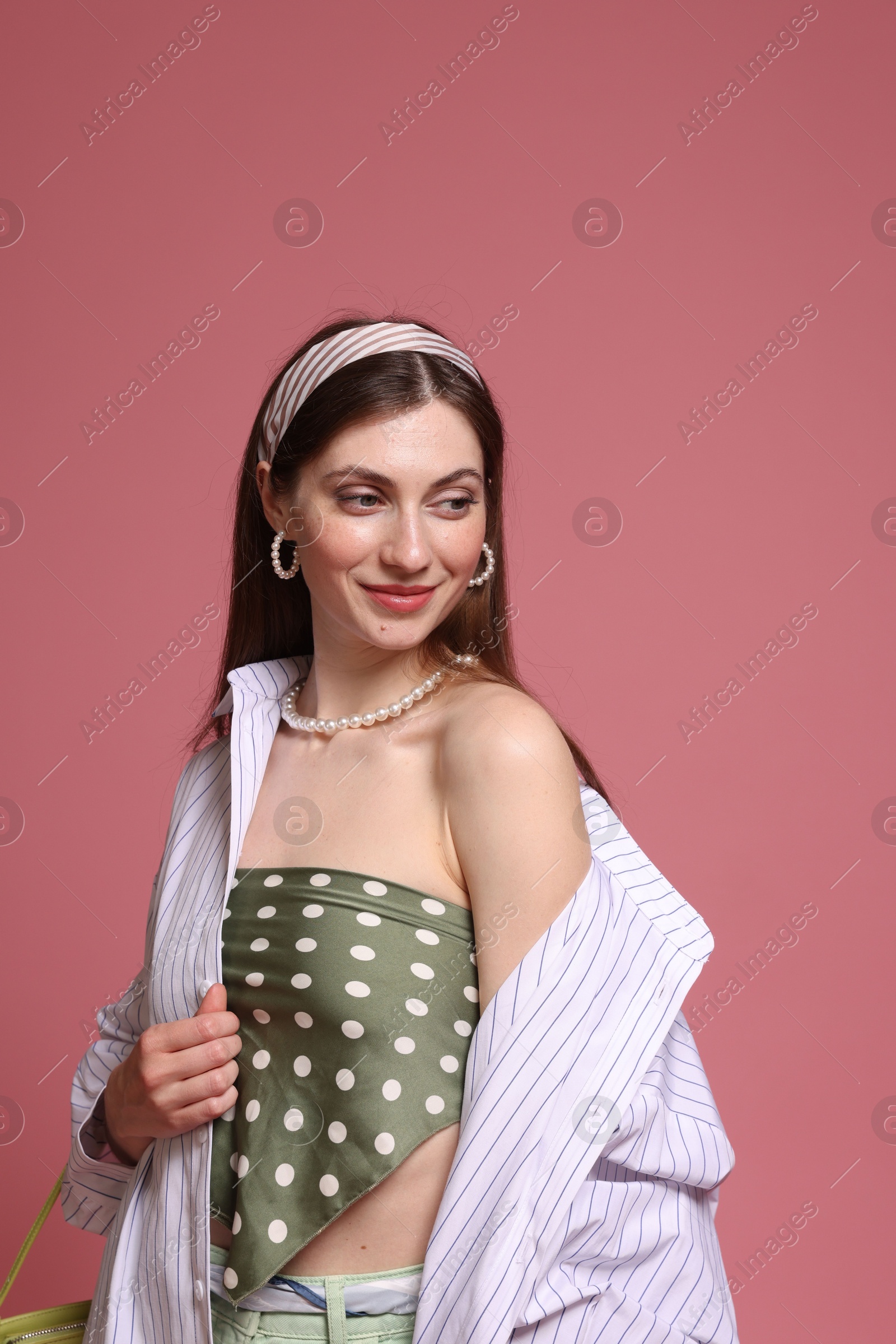 Fashionable portrait of beautiful woman in stylish outfit on pink background Photo of Fashionable portrait of beautiful woman in stylish outfit on pink background