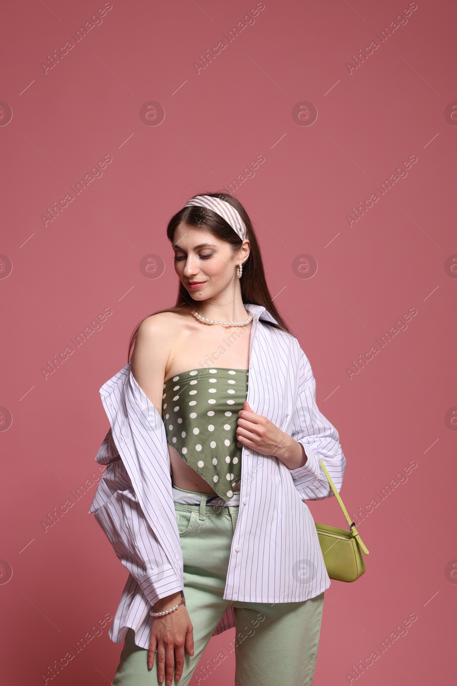 Fashionable portrait of beautiful woman in stylish outfit on pink background Photo of Fashionable portrait of beautiful woman in stylish outfit on pink background