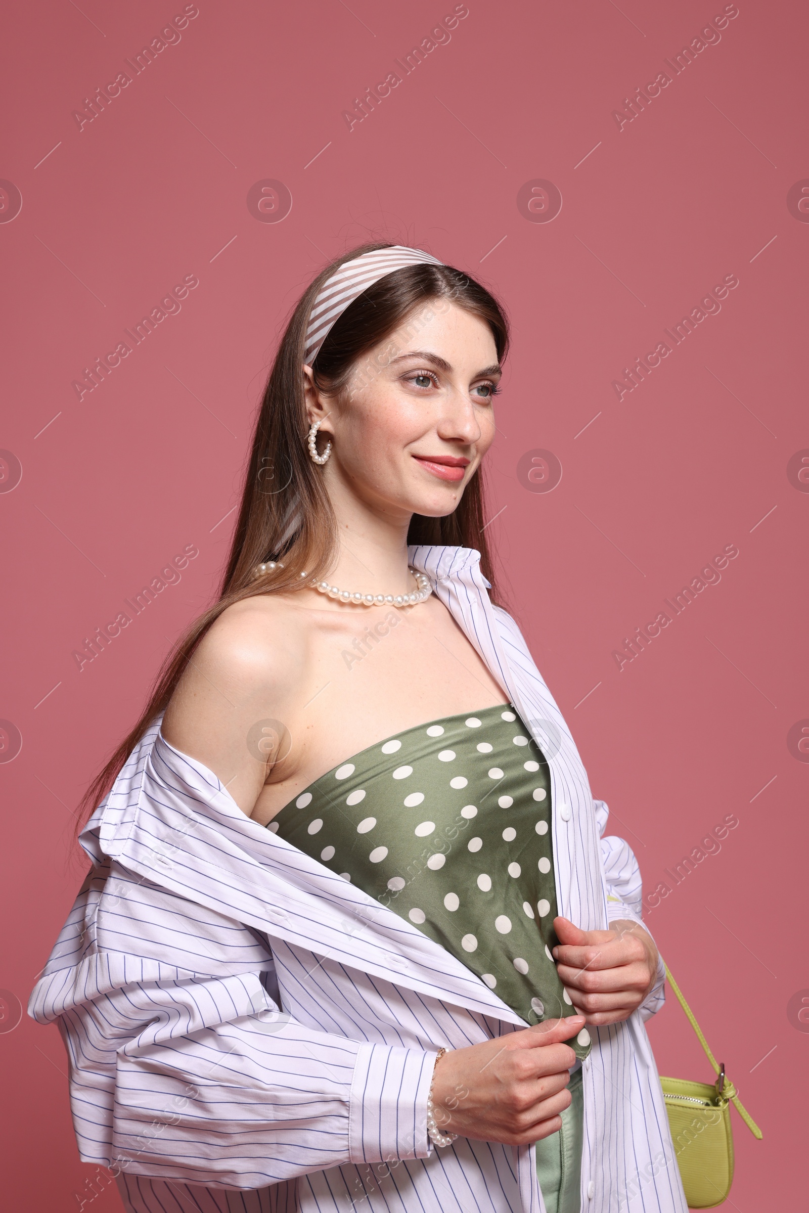 Fashionable portrait of beautiful woman in stylish outfit on pink background Photo of Fashionable portrait of beautiful woman in stylish outfit on pink background