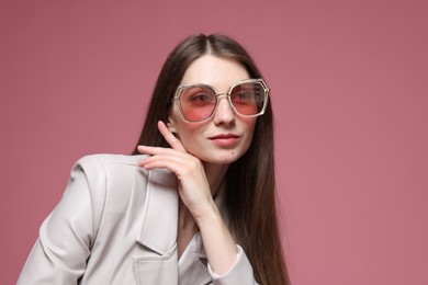 Photo of Fashionable portrait of beautiful woman in stylish outfit on pink background