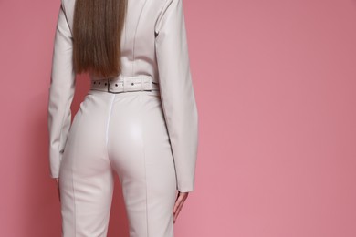 Photo of Woman in stylish outfit on pink background, closeup. Space for text