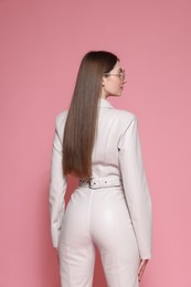 Photo of Woman in stylish outfit on pink background