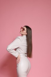 Photo of Woman in stylish outfit on pink background