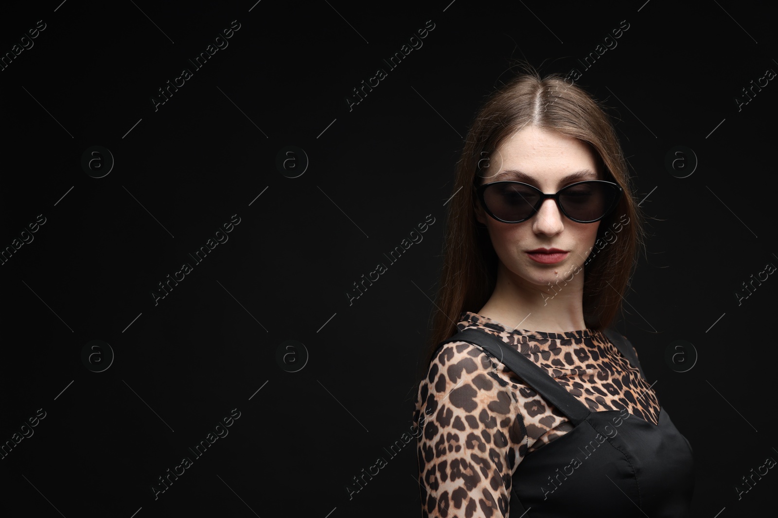 Fashionable portrait of beautiful woman in stylish outfit on black background. Space for text Photo of Fashionable portrait of beautiful woman in stylish outfit on black background. Space for text
