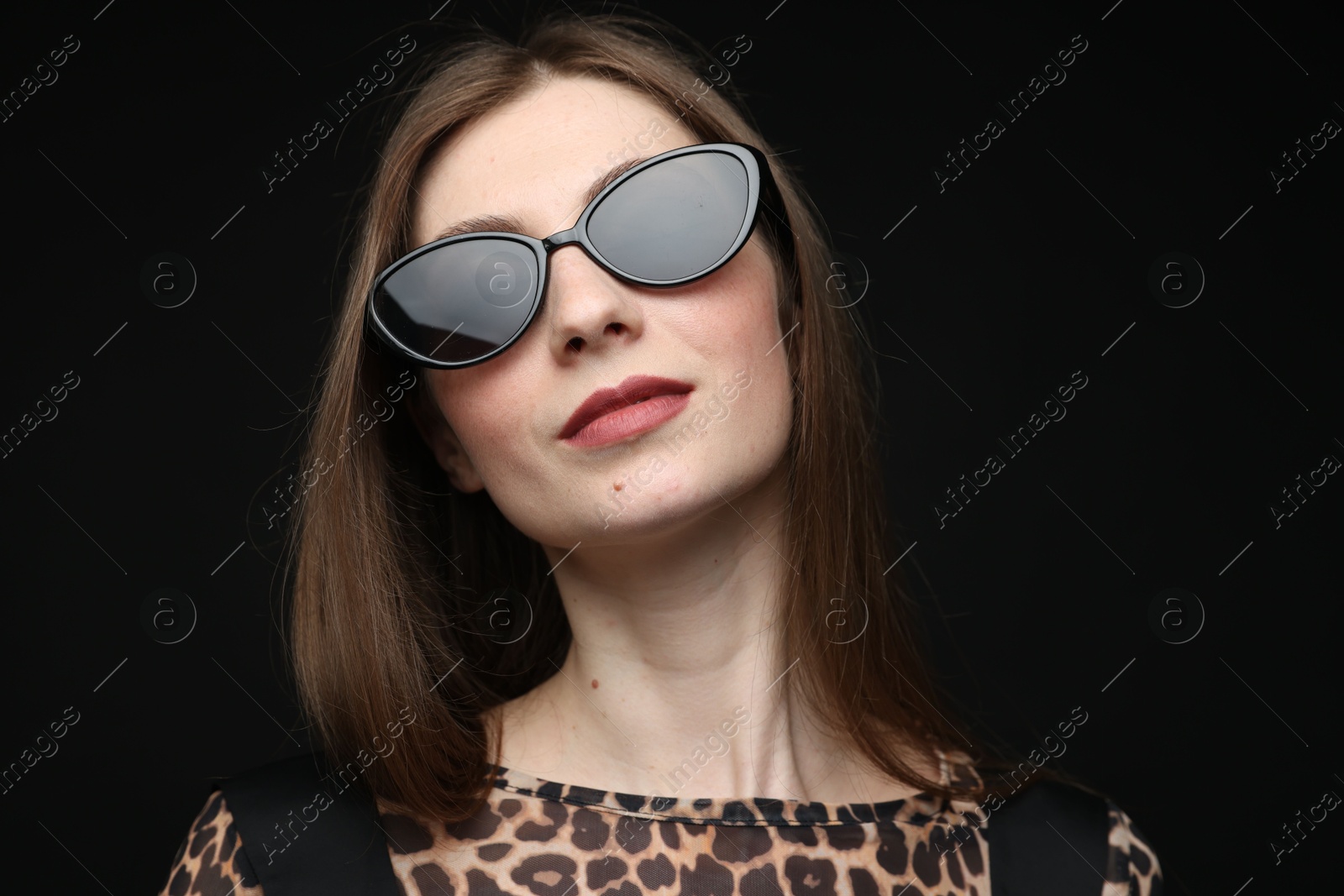 Woman in stylish outfit on black background Photo of Woman in stylish outfit on black background