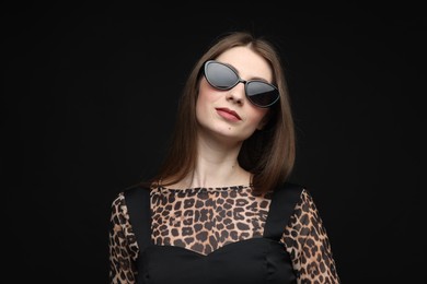 Photo of Fashionable portrait of beautiful woman in stylish outfit on black background