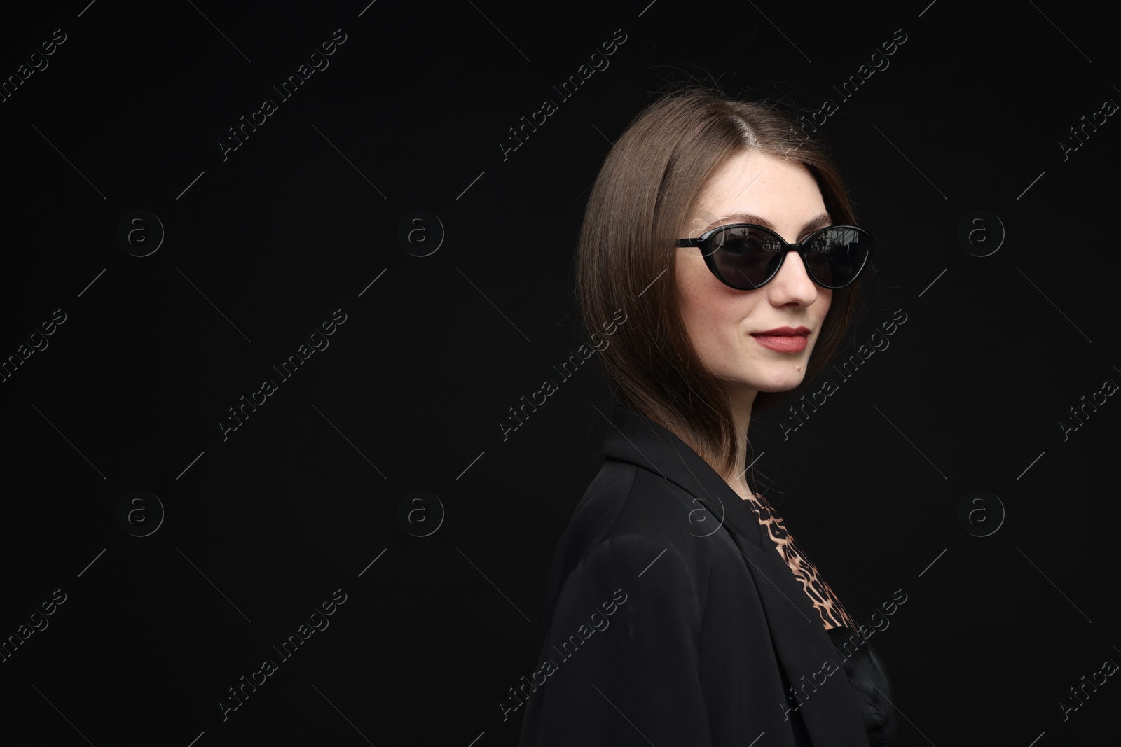 Fashionable portrait of beautiful woman in stylish outfit on black background. Space for text Photo of Fashionable portrait of beautiful woman in stylish outfit on black background. Space for text