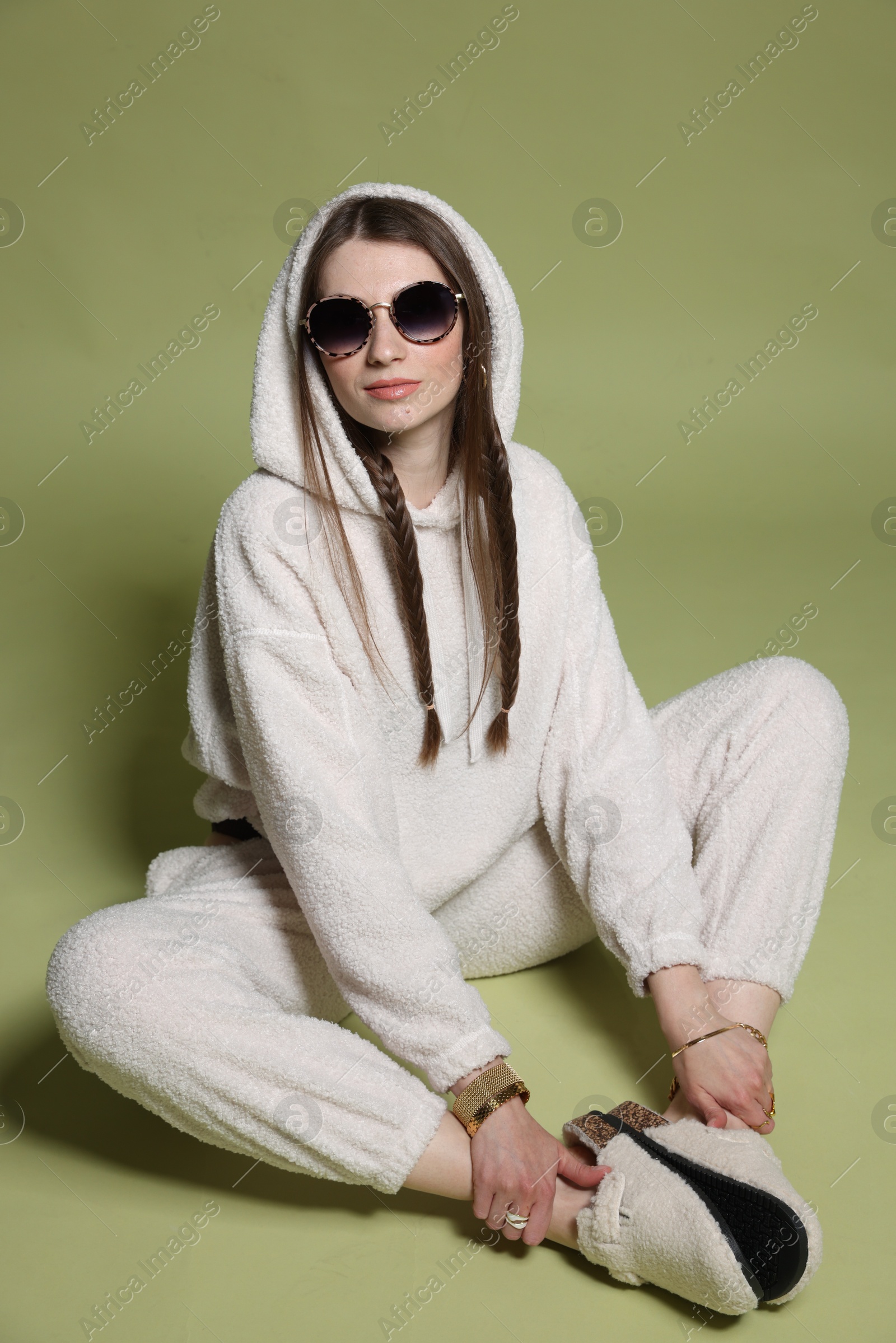 Fashionable portrait of beautiful woman in stylish outfit on green background Photo of Fashionable portrait of beautiful woman in stylish outfit on green background