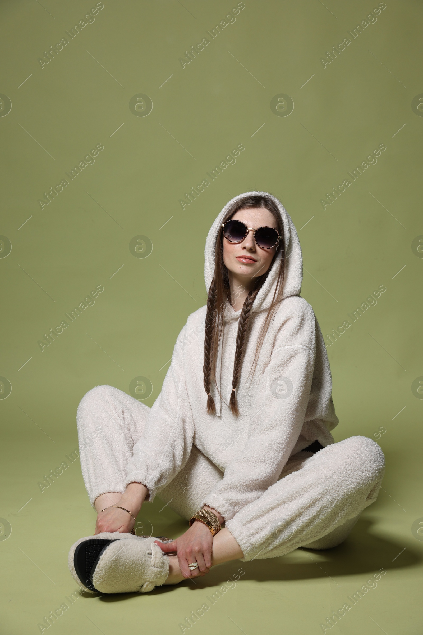 Fashionable portrait of beautiful woman in stylish outfit on green background Photo of Fashionable portrait of beautiful woman in stylish outfit on green background