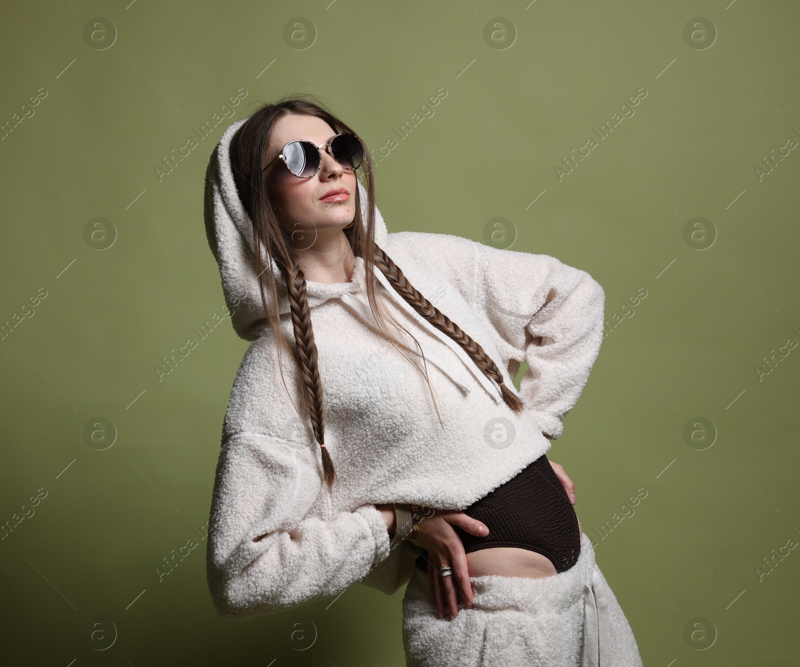 Fashionable portrait of beautiful woman in stylish outfit on green background Photo of Fashionable portrait of beautiful woman in stylish outfit on green background