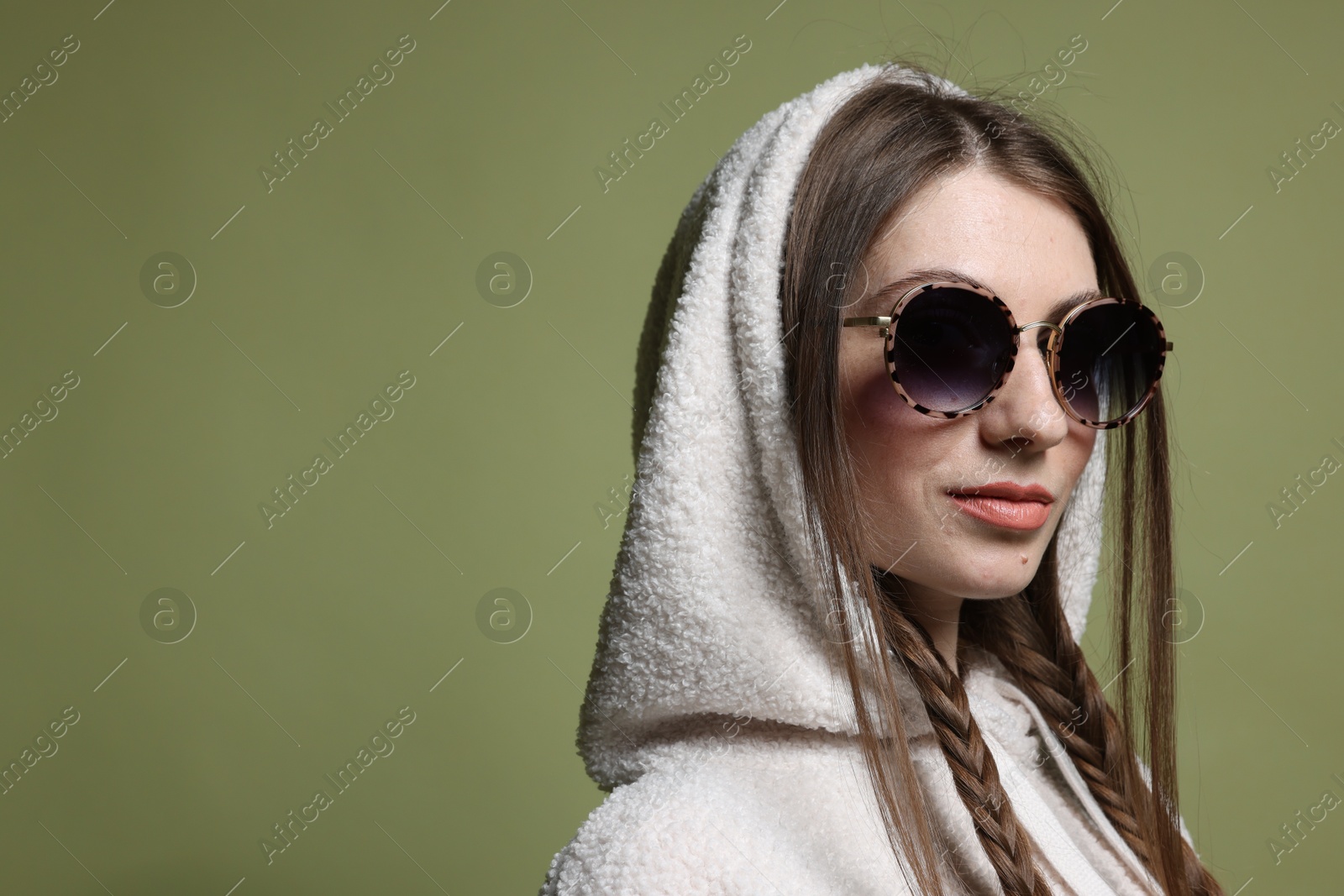 Fashionable portrait of beautiful woman in stylish outfit on green background. Space for text Photo of Fashionable portrait of beautiful woman in stylish outfit on green background. Space for text
