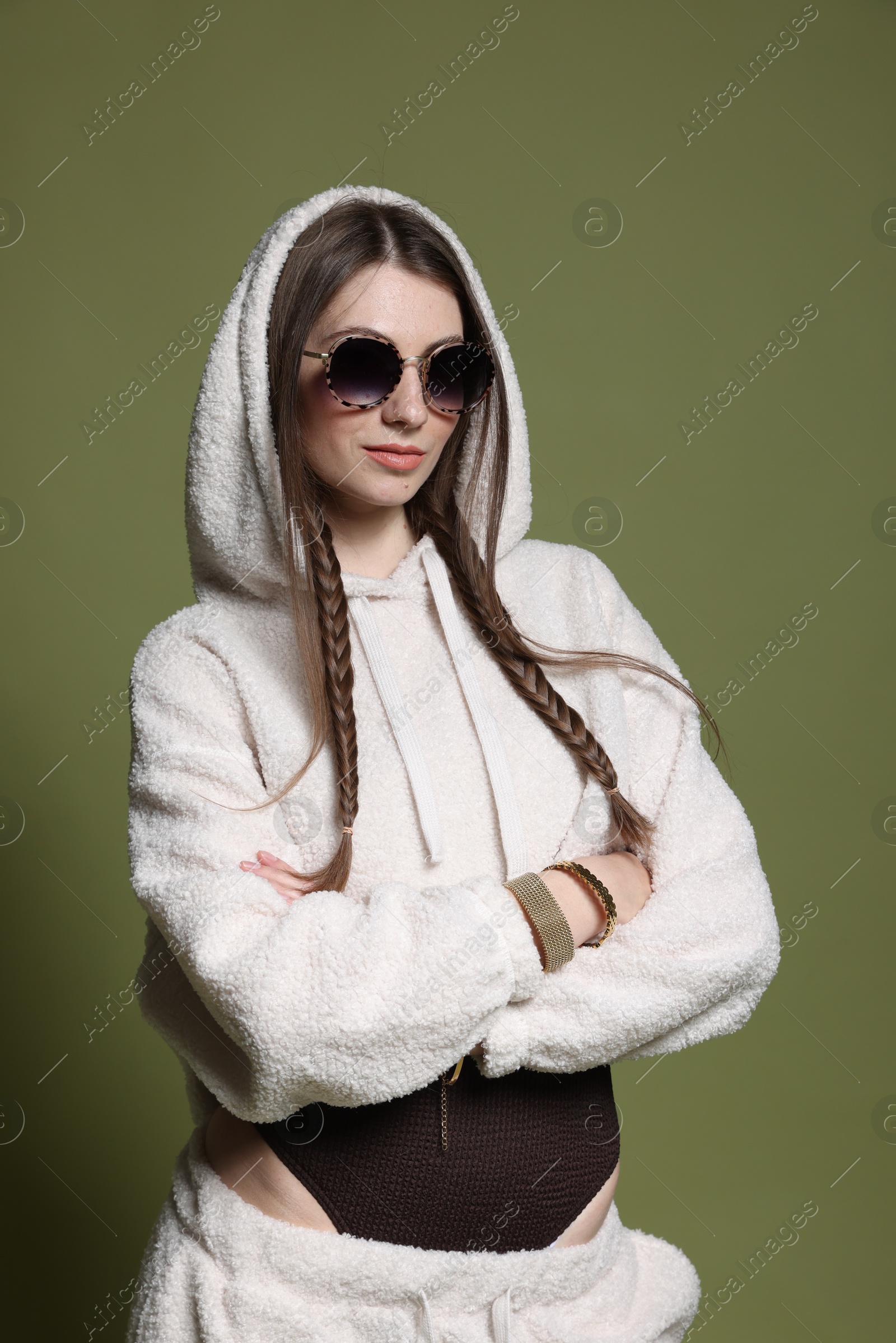 Fashionable portrait of beautiful woman in stylish outfit on green background Photo of Fashionable portrait of beautiful woman in stylish outfit on green background