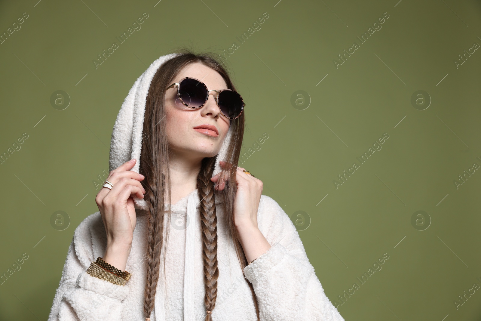 Fashionable portrait of beautiful woman in stylish outfit on green background. Space for text Photo of Fashionable portrait of beautiful woman in stylish outfit on green background. Space for text