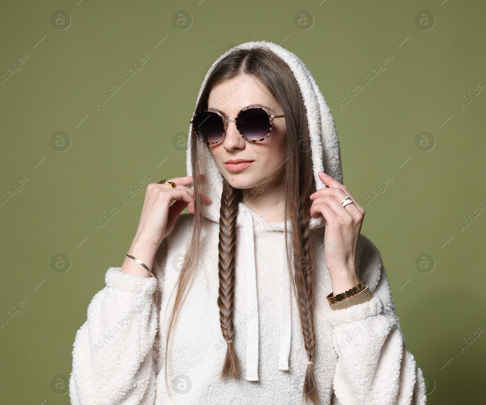 Fashionable portrait of beautiful woman in stylish outfit on green background Photo of Fashionable portrait of beautiful woman in stylish outfit on green background