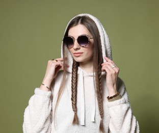 Photo of Fashionable portrait of beautiful woman in stylish outfit on green background