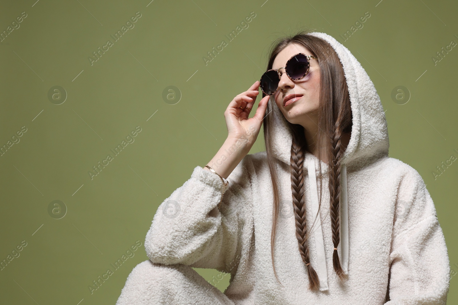 Fashionable portrait of beautiful woman in stylish outfit on green background. Space for text Photo of Fashionable portrait of beautiful woman in stylish outfit on green background. Space for text