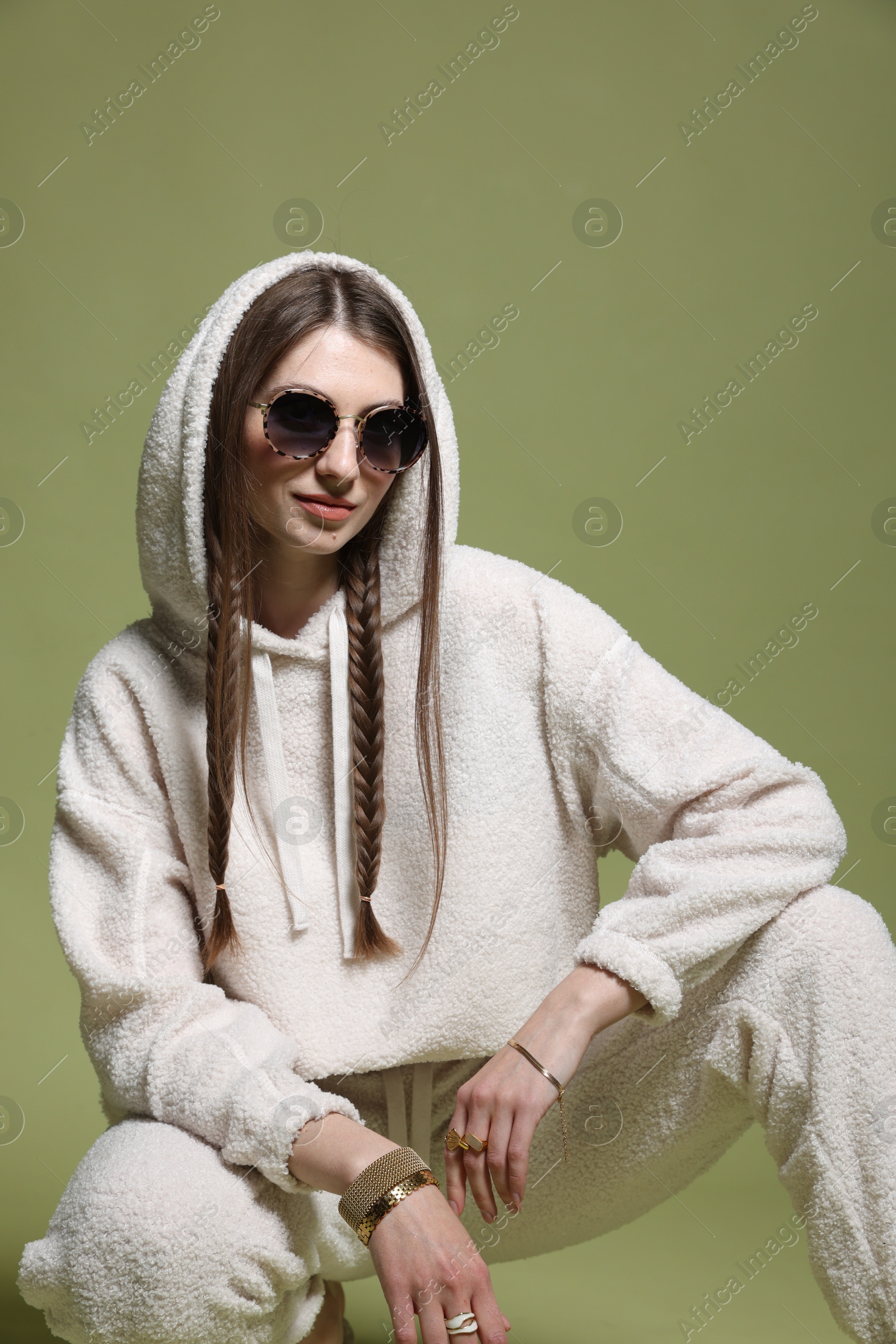 Fashionable portrait of beautiful woman in stylish outfit on green background Photo of Fashionable portrait of beautiful woman in stylish outfit on green background