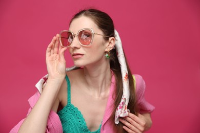 Photo of Fashionable portrait of beautiful woman in stylish outfit on pink background