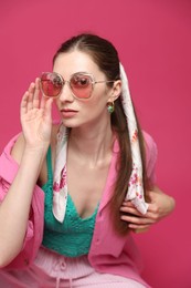 Photo of Fashionable portrait of beautiful woman in stylish outfit on pink background