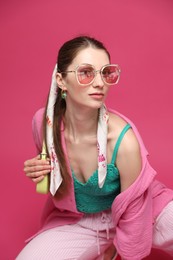 Photo of Fashionable portrait of beautiful woman in stylish outfit on pink background