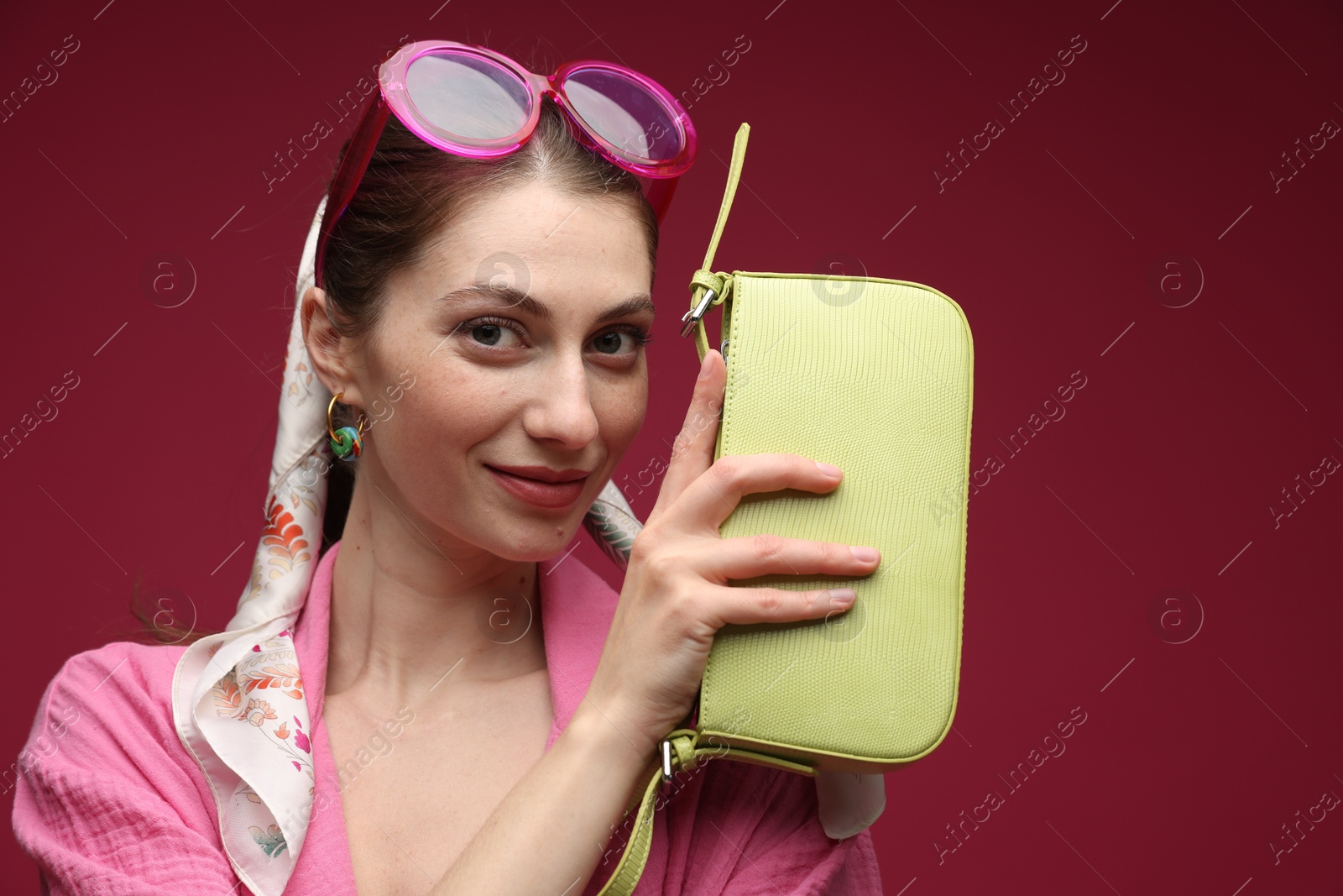 Fashionable portrait of beautiful woman in stylish outfit on dark red background Photo of Fashionable portrait of beautiful woman in stylish outfit on dark red background