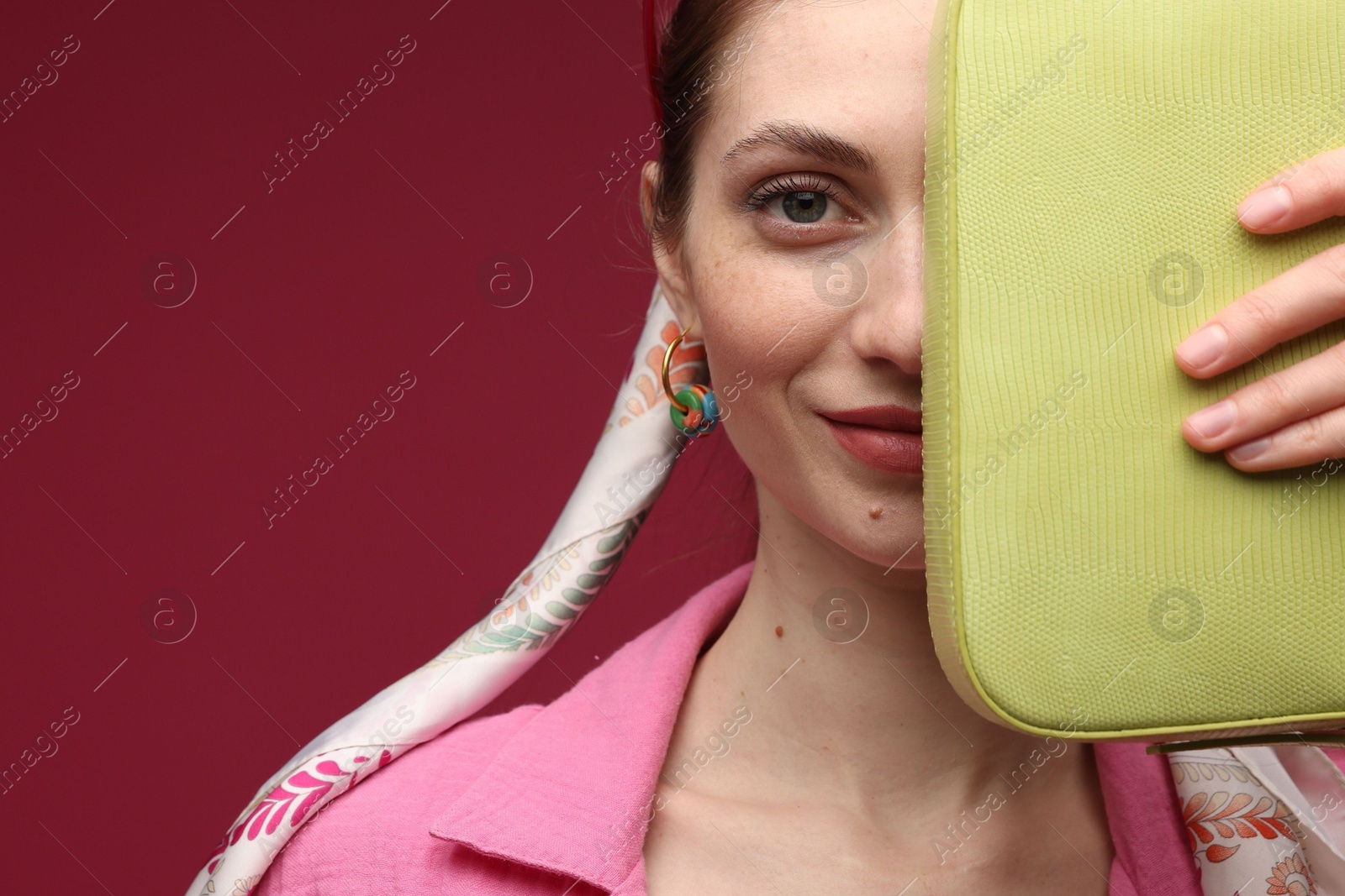 Woman in stylish outfit on dark red background, closeup. Space for text Photo of Woman in stylish outfit on dark red background, closeup. Space for text