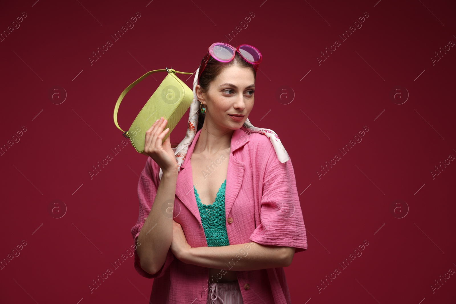Fashionable portrait of beautiful woman in stylish outfit on dark red background Photo of Fashionable portrait of beautiful woman in stylish outfit on dark red background