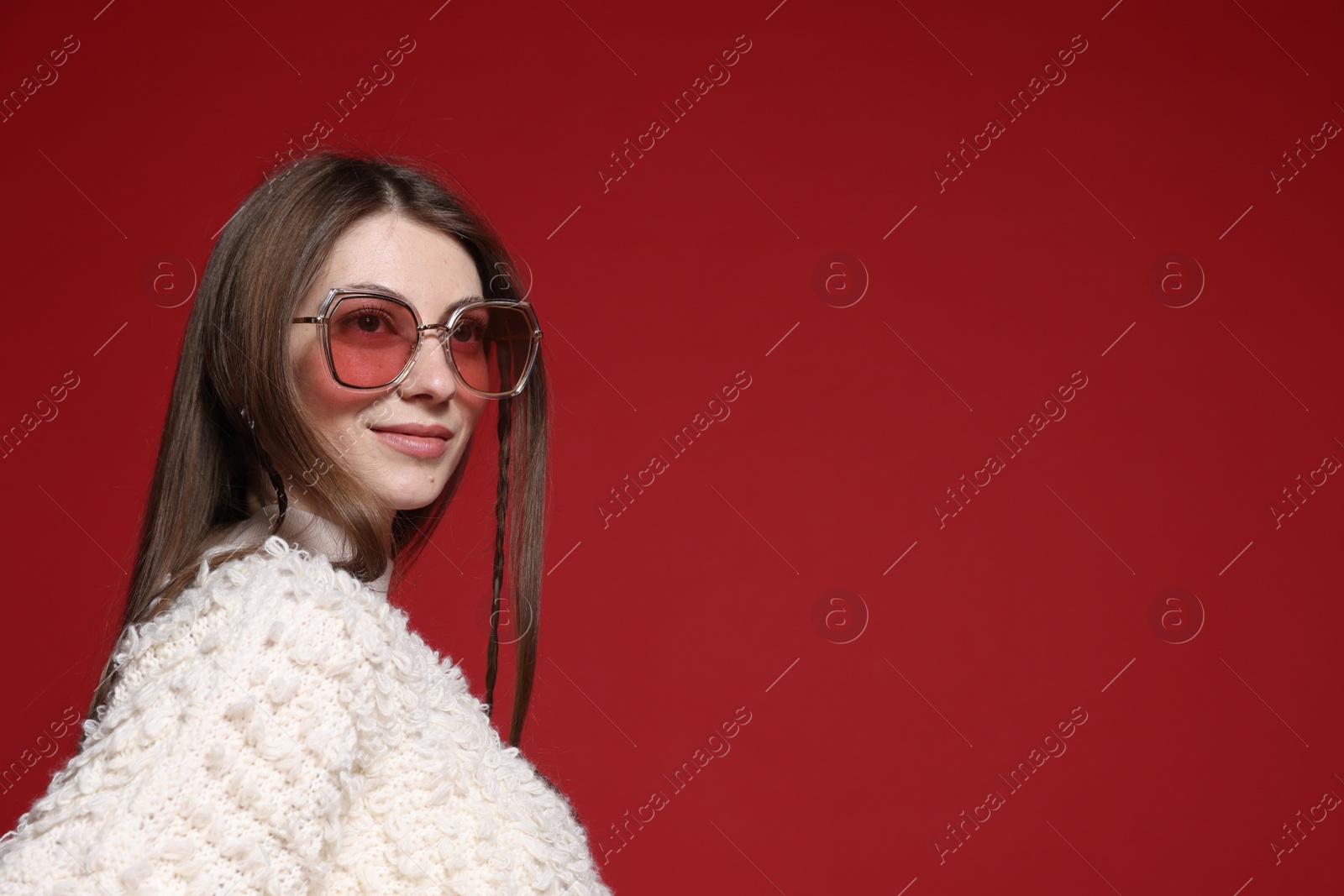 Fashionable portrait of beautiful woman in stylish outfit on red background. Space for text Photo of Fashionable portrait of beautiful woman in stylish outfit on red background. Space for text
