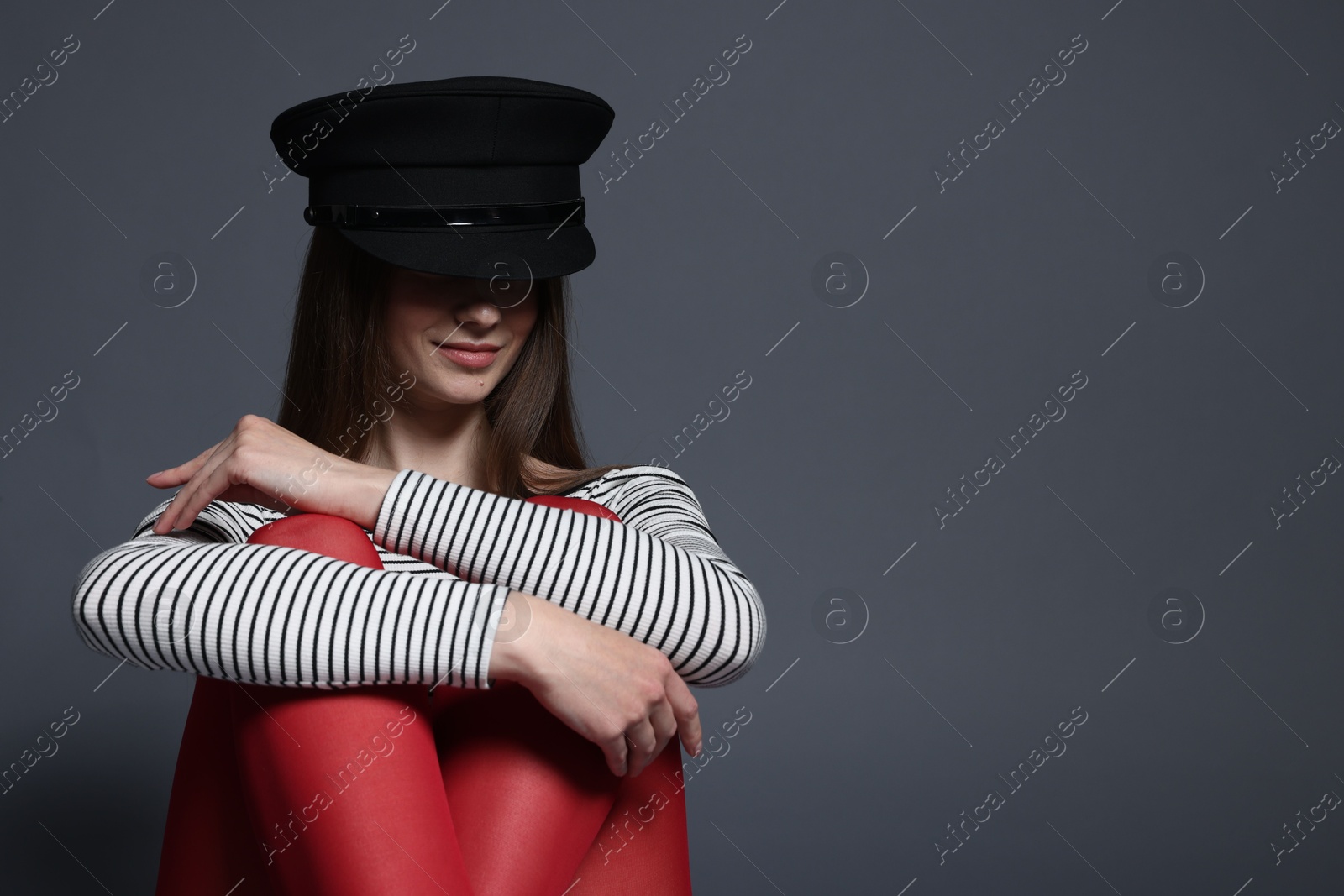 Fashionable portrait of beautiful woman in stylish outfit on grey background. Space for text Photo of Fashionable portrait of beautiful woman in stylish outfit on grey background. Space for text