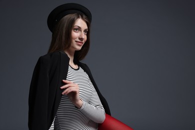 Photo of Fashionable portrait of beautiful woman in stylish outfit on grey background. Space for text