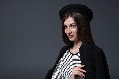Photo of Fashionable portrait of beautiful woman in stylish outfit on grey background. Space for text
