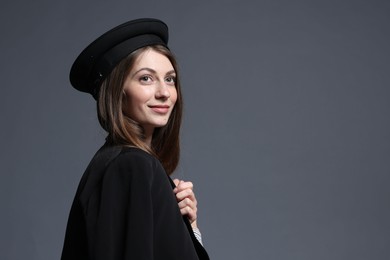Photo of Fashionable portrait of beautiful woman in stylish outfit on grey background. Space for text