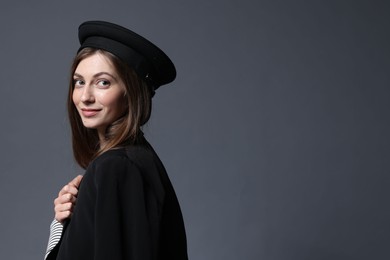 Photo of Fashionable portrait of beautiful woman in stylish outfit on grey background. Space for text